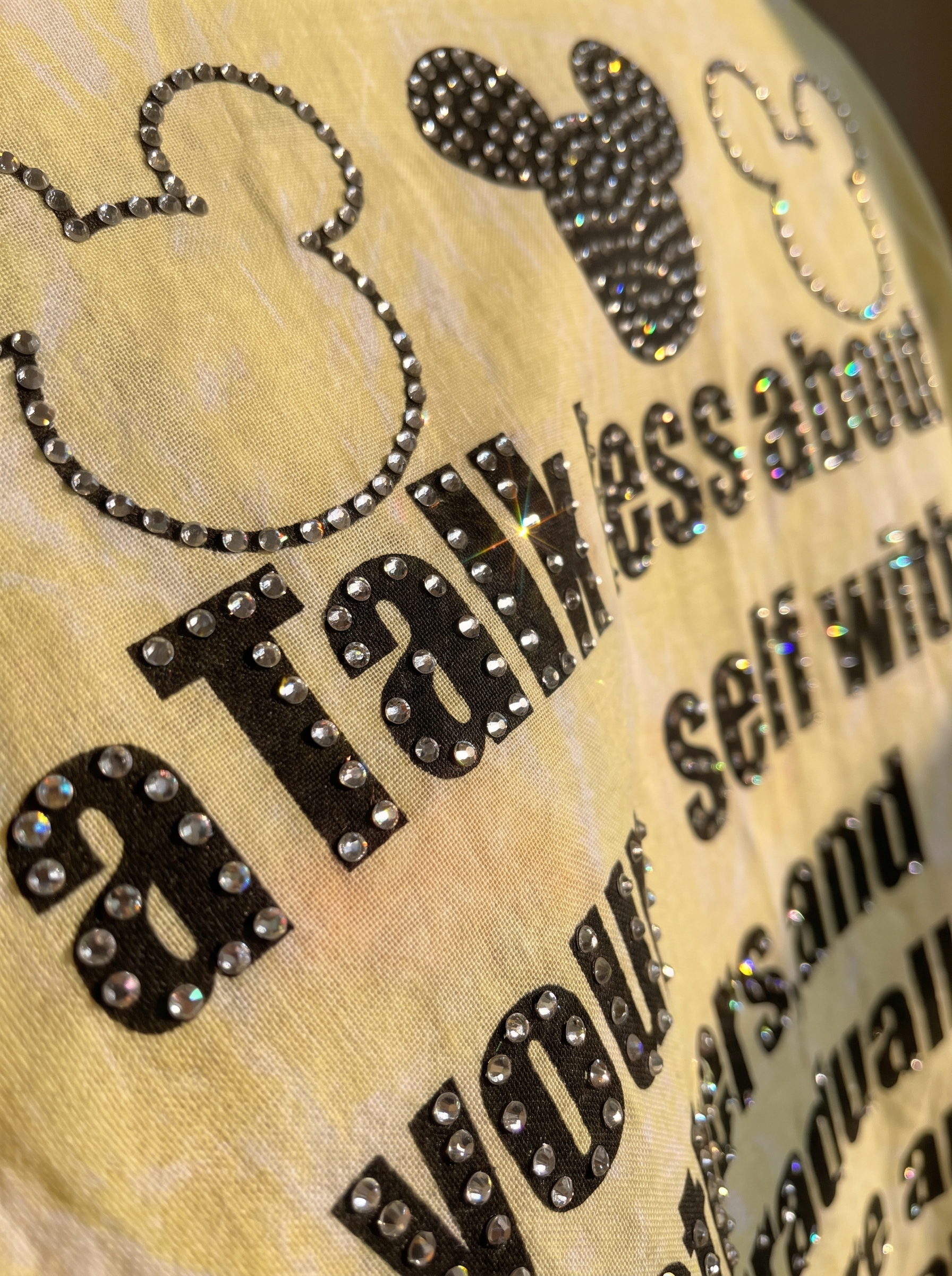 Talk Less oversized Kora cotton shirt, close up of the hotfix rhinestones tracing the back print