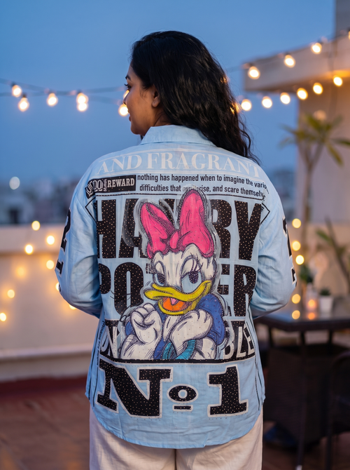 Back view of the Breaking News oversized Kora cotton shirt in sky blue showing the full back print