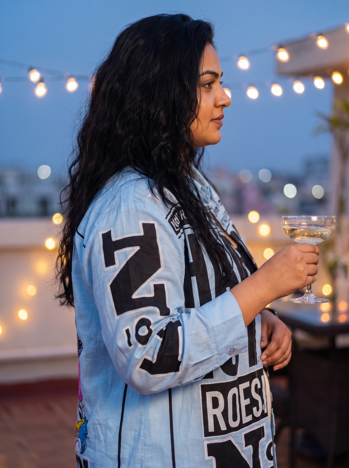Sleeve detail of the Breaking News oversized Kora cotton shirt worn open, showing the printed oversized sleeve