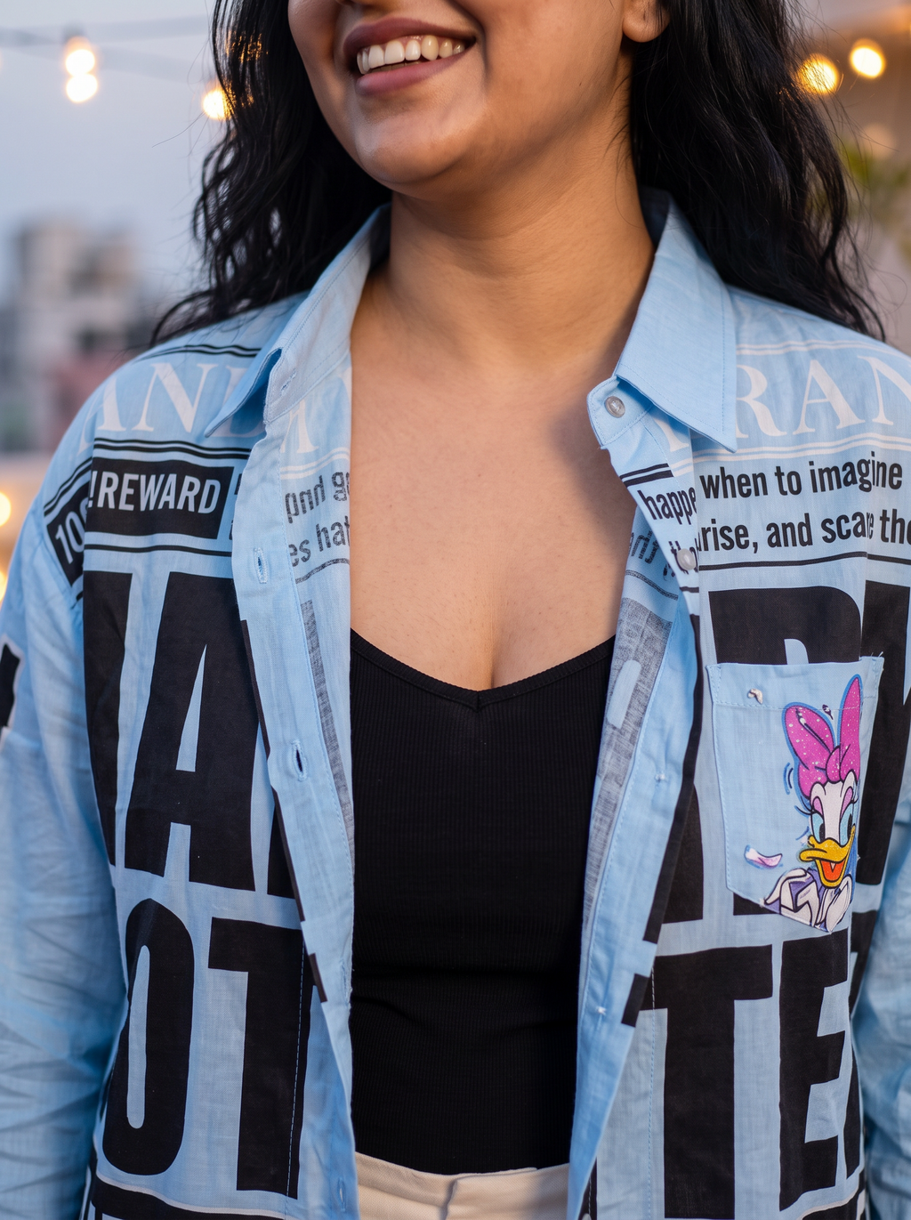Collar and shoulder detail of the Breaking News oversized Kora cotton shirt worn open on the model