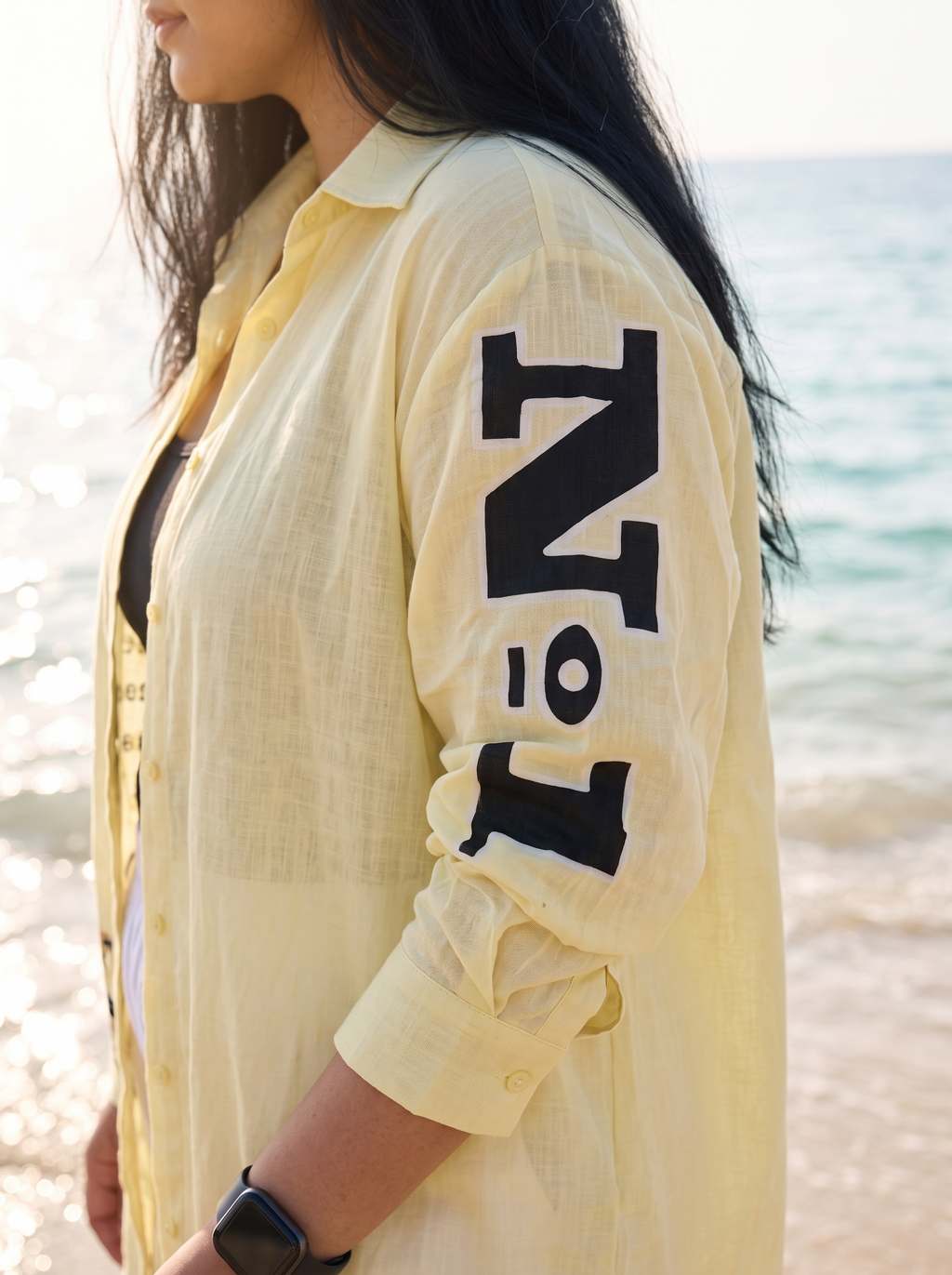 Sleeve detail of the Front Page oversized Kora cotton shirt showing the No 1 print