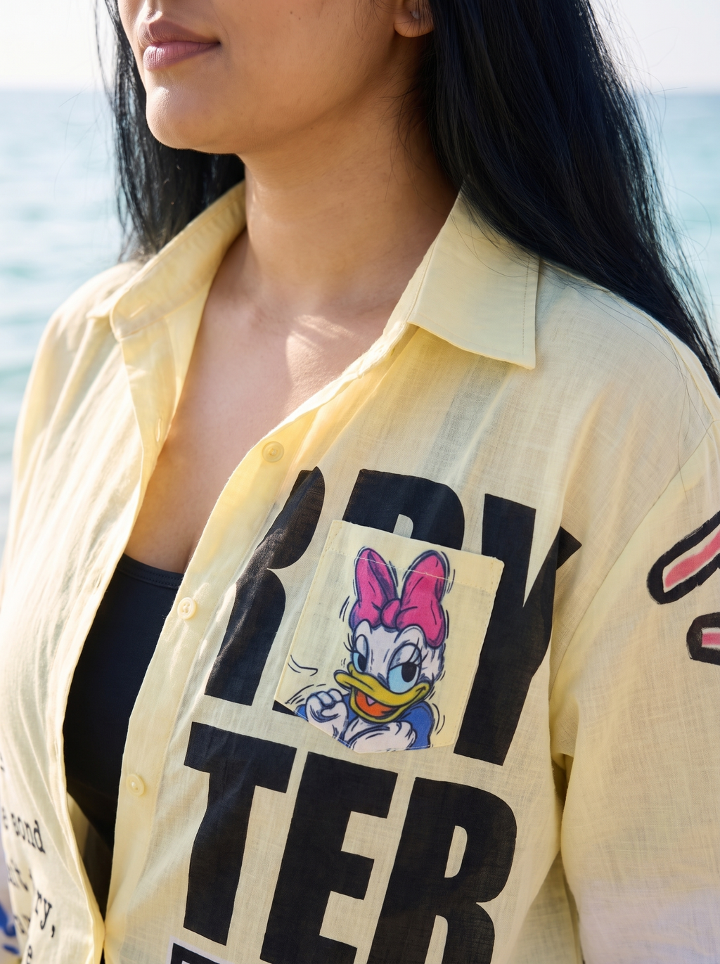 Collar and shoulder detail of the Front Page oversized Kora cotton shirt worn open on the model