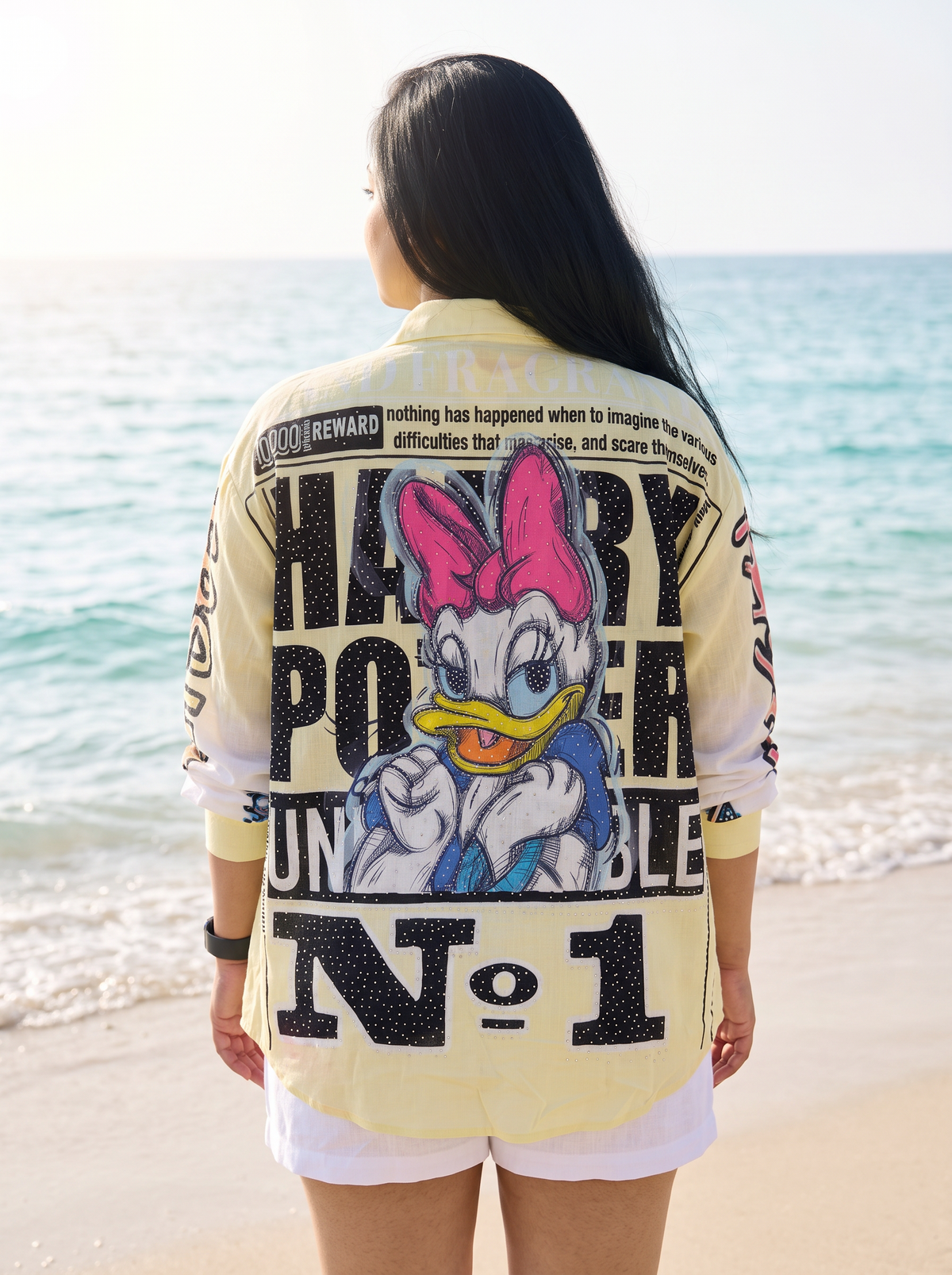 Back view of the Front Page oversized Kora cotton shirt showing the newspaper print with rhinestone detail