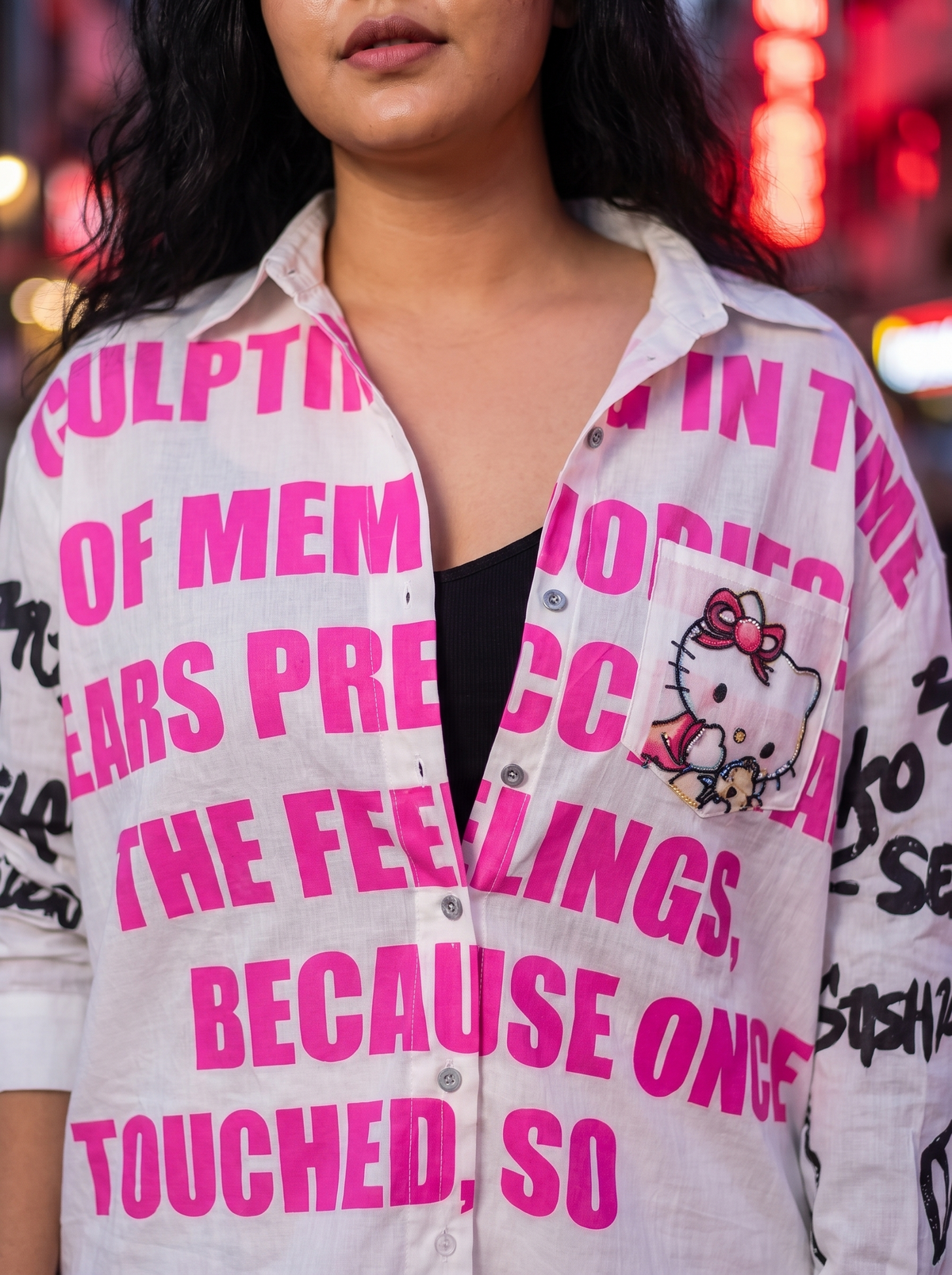 Close up of the Unforgettable oversized Kora cotton shirt worn open showing the front print and pocket detail